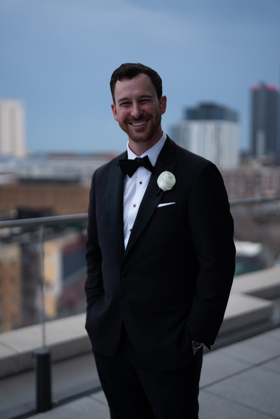 Groom in a rooftop portrait, before editing; photograph by Michele Maloney