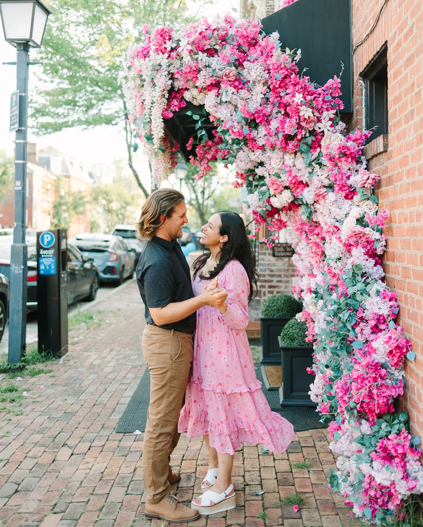 Couple beside a floral arch, after editing