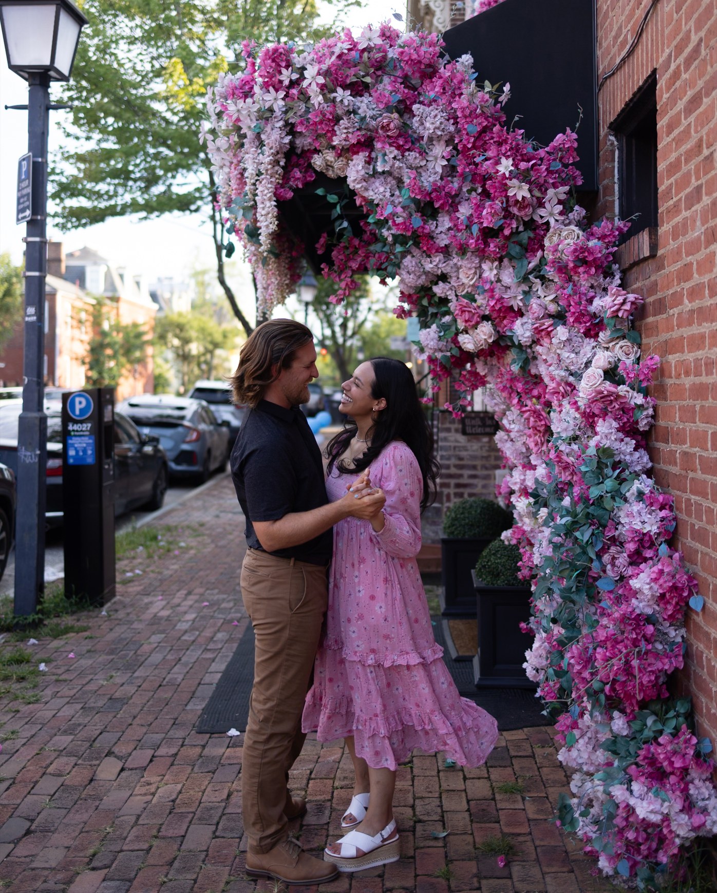 Couple beside a floral arch, before editing