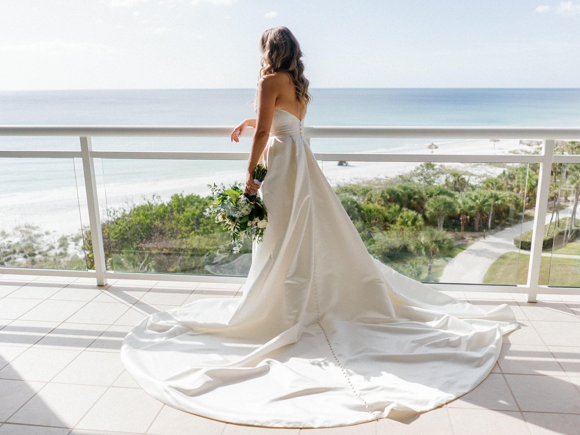 Bride overlooking the ocean in natural light