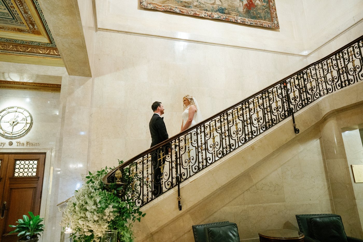 Wedding couple on an ornate staircase, photographed by Michele Maloney and edited by InPix.Me