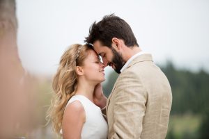 bridge and groom being romantic outdoors