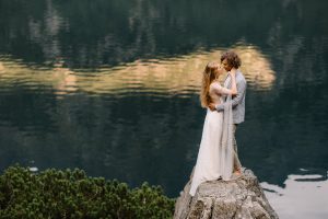 portrait of wedding couple on the background on smooth water surface