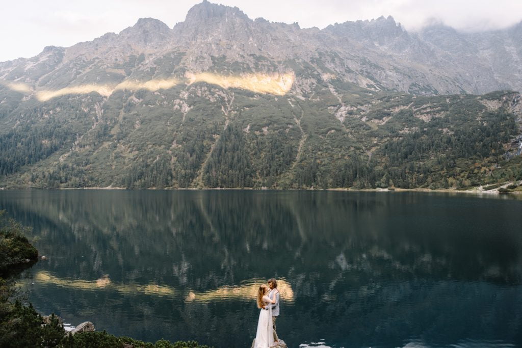 portrait of wedding couple on the background on smooth water surface