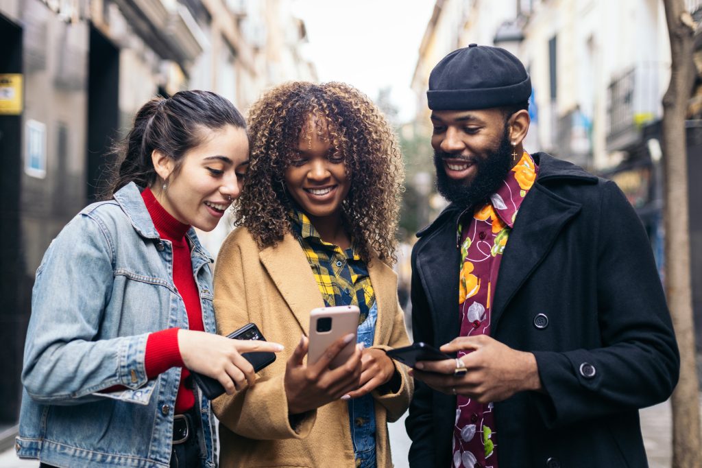 friends using smartphone in the street